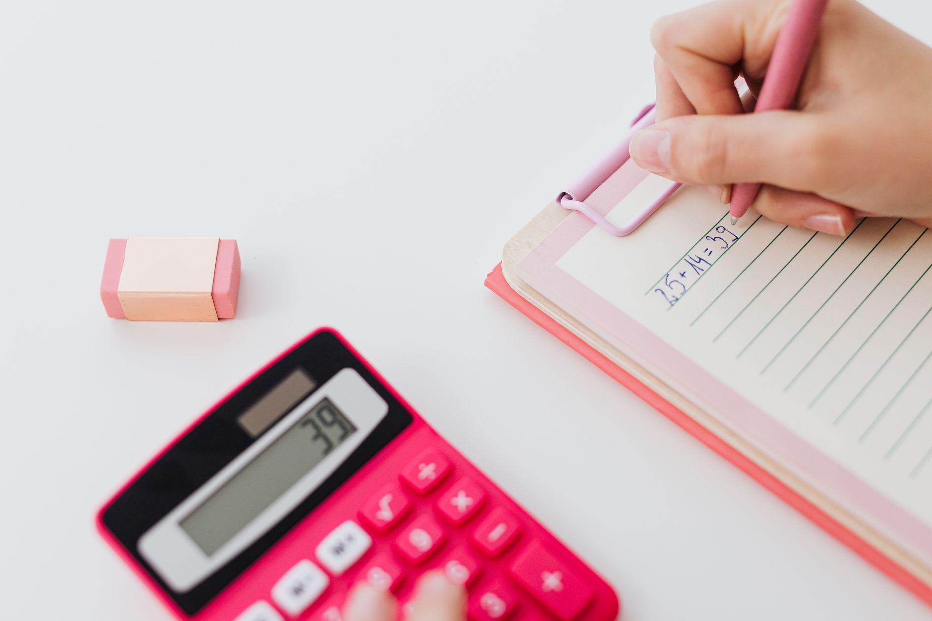 caderno e calculadora ao lado de utensílios de confeitaria
