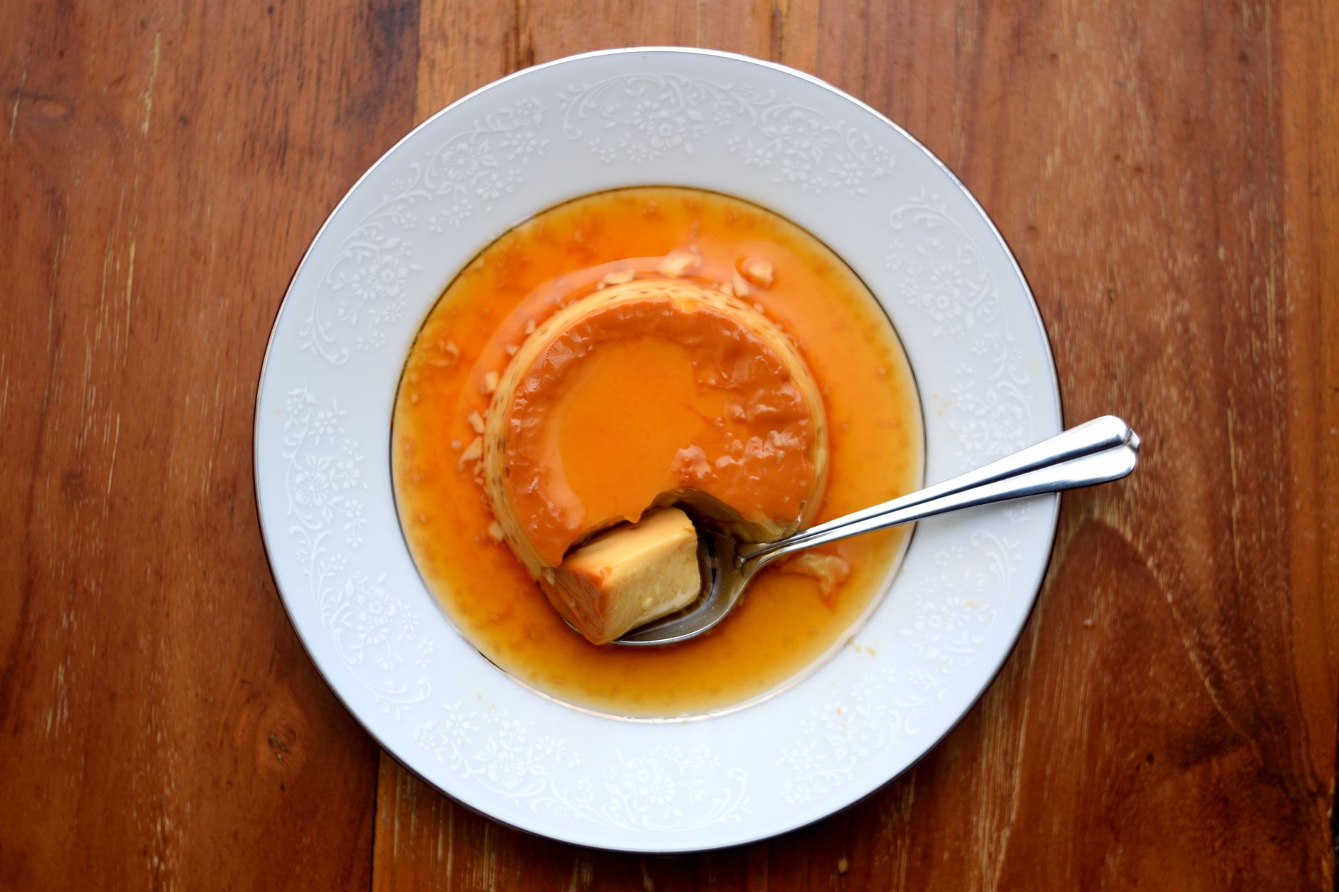 pudim de leite liso com calda de caramelo em um prato